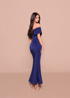 Woman wearing a blue off-shoulder dress on a beige background