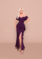 Woman wearing a purple off-shoulder dress with a slit on a beige background