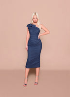 Woman wearing a navy one-shoulder dress against a beige background