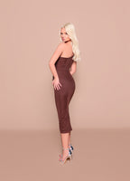 Woman wearing a brown strapless dress against a beige background
