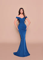 Woman wearing a blue off-shoulder gown against a beige background