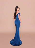 Woman wearing a blue off-shoulder evening gown on a beige background