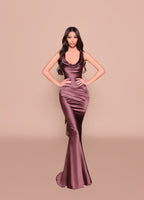 Woman wearing a satin evening gown on a beige background