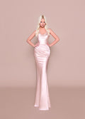Woman wearing a pink evening gown against a beige background