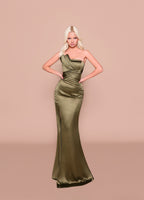 Woman wearing an olive green one-shoulder evening gown against a beige background