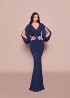 Woman wearing a blue evening gown against a beige background