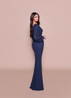 Woman wearing a navy blue evening gown against a beige background