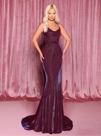 Woman in a purple evening gown against a pink curtain backdrop