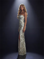 Woman in a strapless, sequined evening gown with a slit on a dark background