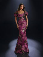 Woman wearing a purple floral evening gown against a dark background