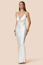 Woman wearing a white satin gown on a beige background