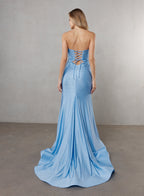 Woman wearing a blue strapless gown with a lace-up back against a plain background