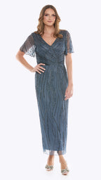 Woman wearing a blue evening gown with sheer sleeves on a white background
