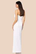 Woman wearing a strapless white dress on a beige background