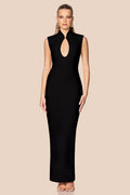 Woman wearing a black sleeveless dress with a deep neckline on a beige background