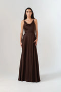 Woman wearing a brown evening gown on a white background